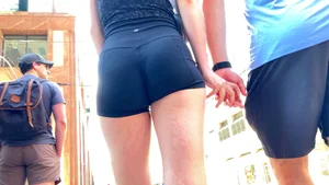 Perfect ass in spandex shorts and hot thighs closeups at the crosswalk on the street creepshots