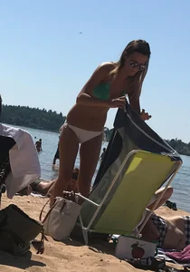 Swedish beach blonde girl in white and green bikini