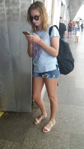 Girl in Denim Torn Mini-Shorts and Sandals in Subway Candid