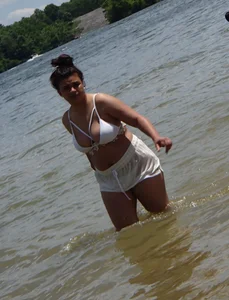 Big boobed brunette on the beach in white bikini