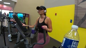 Smoking hot brunette working out at the gym in tight leggings