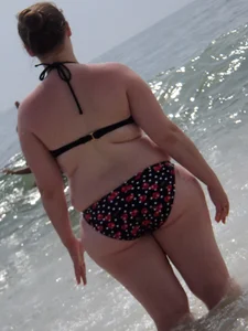 Fat chick with big boobs at the beach in a bikini