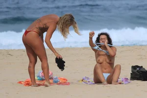 Sexy girls topless on a nude beach showing their nice tits