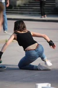 Hot brunette skateboarder in tight jeans and with hard nipples