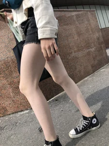 Cute candid teen with pale slim legs in shorts