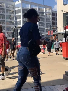 Bunch of girls in various outfits at a Cardinals baseball game