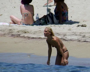 Small boobed topless milf on the beach