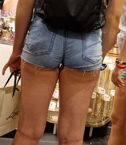 A Cute Young Girl in a Top And Denim Mini Shorts at the Shop Photos