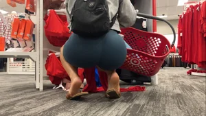 Latina squatting in spandex shorts