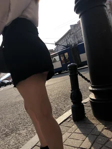 Awesome candid chick wearing a blouse and a skirt crossing the street on high heels, showing a little cheek