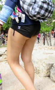 Girl with slight cheeks in little spandex shorts
