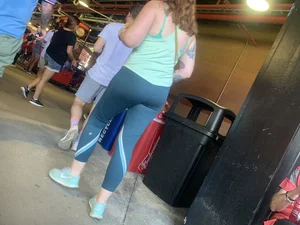 Bunch of girls in various outfits at a Cardinals baseball game
