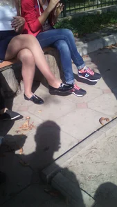 Nice crossed legs in pantyhose creepshot - girl sitting on a street bench