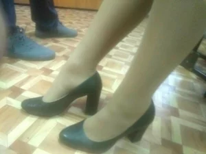 Closeups of college girls' legs and feet in pantyhose and various shoes (including high heels) in classrooms
