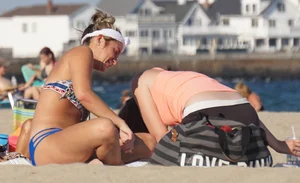Beach babe in a blue bikini with thick friend in shorts