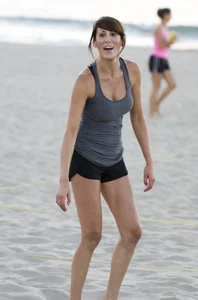 Hot girls playing beach volleyball in bikinis and shorts