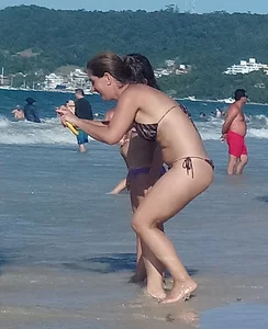 Milf on the beach in a thong bikini