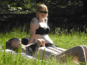 Two sexy friends in black bikinis laying out