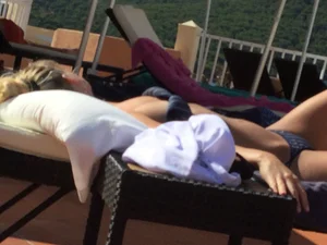 Blonde laying out in a blue bikini with a sexy body