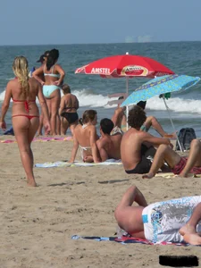 Sexy mom and daughter in red thongs at the beach