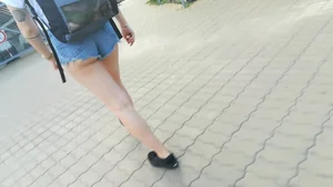Girl walking in denim shorts showing some of her ass cheeks