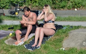 Thick blonde laying out in the sun in a bikini with her boyfriend