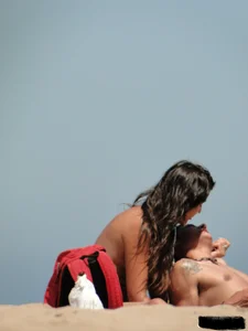 Topless lady on the beach in a gold thong with a nice ass