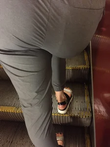 Booty in Pants Closeup on an Escalator, Girl in Grey Pants And Sandals