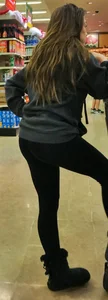Fit shopping brunette girl in leggings and a hoodie with a nice ass