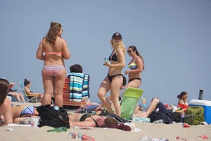 Two thick white girls in bikinis on the beach with big asses