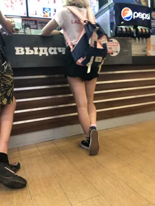 Teen with Fit Muscular Legs in Shorts Food Court Candid