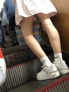 Cute Girl in a Dress with Thin Hot Legs Standing on the Subway Escalator Closeup Creepshots Gallery