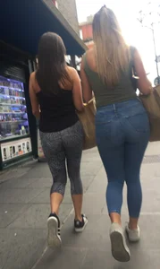 Sexy girl walking in grey patterned leggings with friend in tight jeans