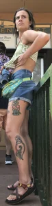 Tatted up hippie in short jean shorts with a nip slip