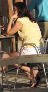 Lady in flop flops while eating showing her feet