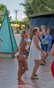Big boobed blonde milf dancing by the pool in a bikini