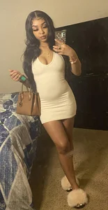 Cute girl in a dress mirror selfie in bedroom