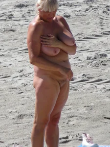 Mature blonde lady on a nude beach with big boobs