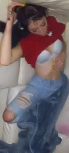Girl in Torn Jeans Sleeping on the Couch With Her Blouse Pulled Up Revealing Her Breast in a Bra