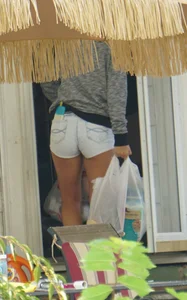 Girl next door teen neighbor bringing in groceries in short jean shorts