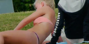 Three sexy girls in bikinis exercising at the park