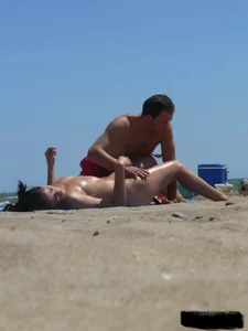 Purple thong topless lady on the beach gets oiled up by her husband