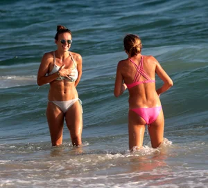 Sexy beach girl in bikini with her other sexy friend