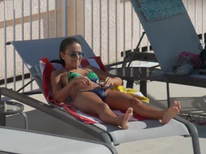 Hot milf sunbathing in a thong by pool and swimming