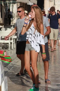 Sexy skinny blonde eating ice cream in short tight grey shorts