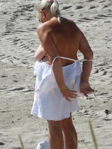 Mature blonde lady on a nude beach with big boobs