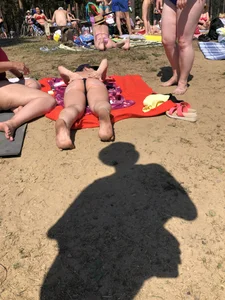 Hot beach candid chick covering her ass with sun lotion