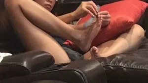 Girl in Mini Shorts Filing Her Toenails