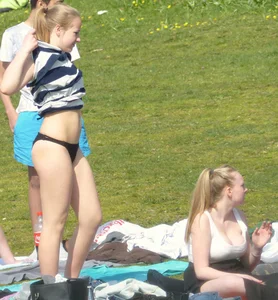 Teen taking off her dress in the park