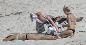Florida blonde in blue and black bikini on the beach